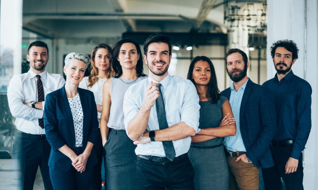 Essential Real Estate Services: What Homebuyers Need to Know Before Closing 20 Group of professionals in business attire, standing together, smiling confidently ready to work for homebuyers