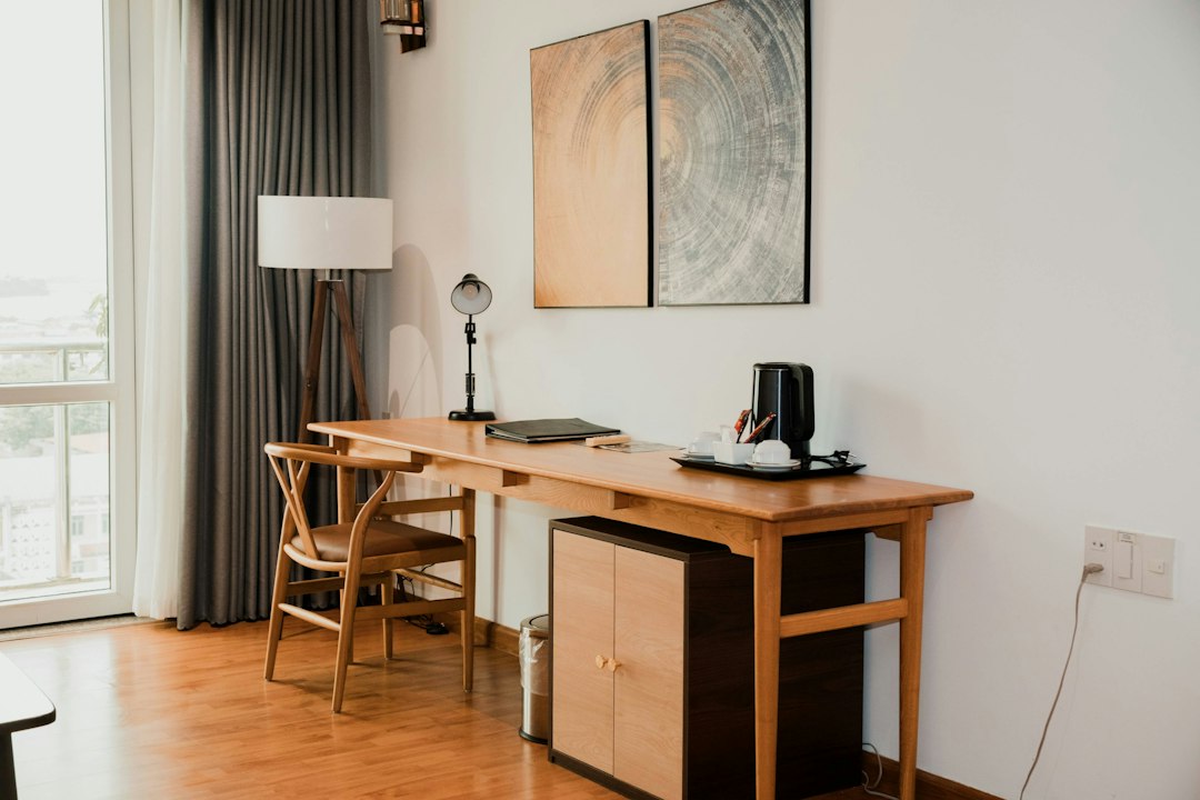 Top 5 Direct Booking Website Builders for Independent Short-Term Rental Hosts 3 A laptop sits on a desk in a bright, modern home, symbolizing the technology behind a direct booking website for a short-term rental.
