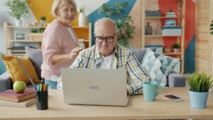 Professional short-term rental host managing their direct booking website on a laptop in a bright, modern living room.