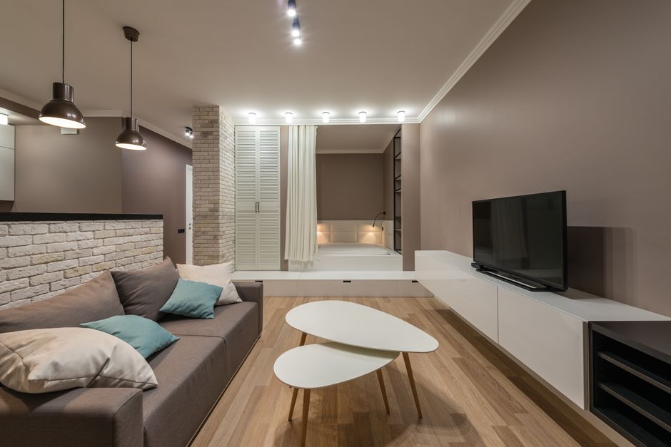 A tablet rests on a coffee table in a sunlit, modern living room, illustrating the central role of digital tools in today's real estate journey.