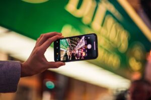 Person's hand holding a smartphone with a map application open, with the blurred background of a pleasant Santa Rosa subur...